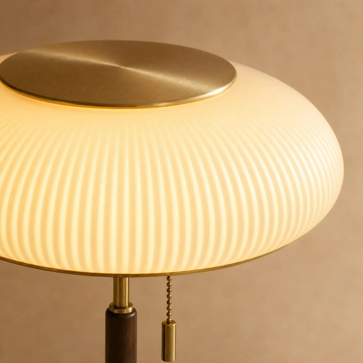 Détail du verre opalin nervuré allumé et du disque doré brossé de la lampe Milari | Delvanie