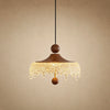 Petite suspension Aubine, chapeau de bois teinté noyer et frange d'acrylique givré, allumée